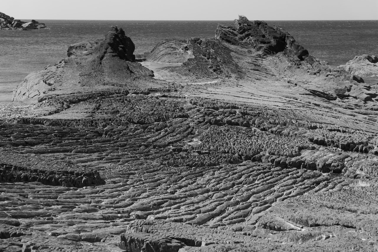Ripples. Ridged rock running out towards the sea.